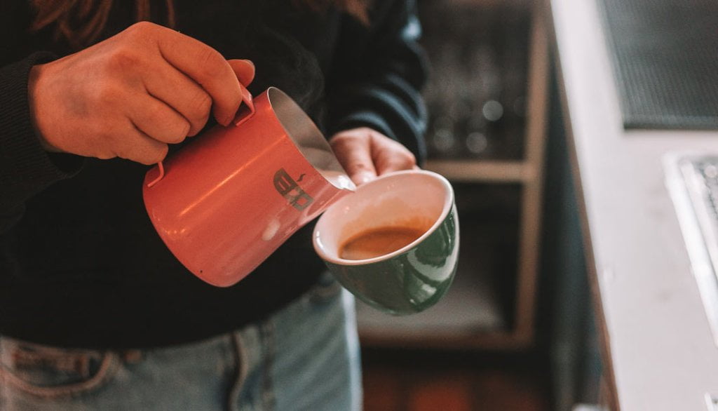 Person Pouring coffee into a cup